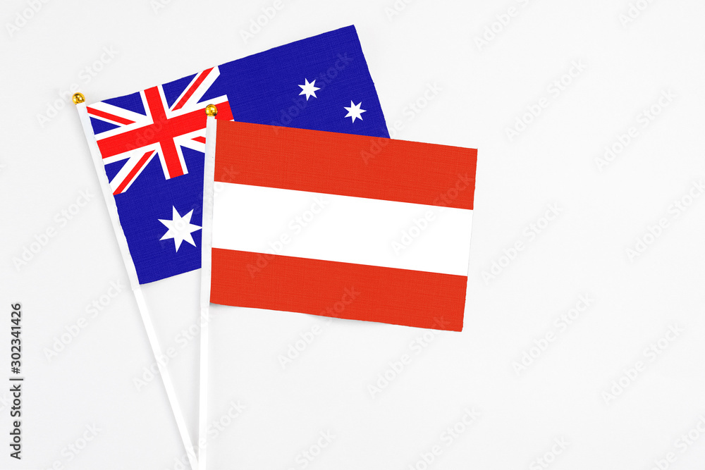 Austria and Australia stick flags on white background. High quality fabric, miniature national flag. Peaceful global concept.White floor for copy space. Austria and Australia stick flags on white background. High quality fabric, miniature national flag. Peaceful global concept.White floor for copy space.