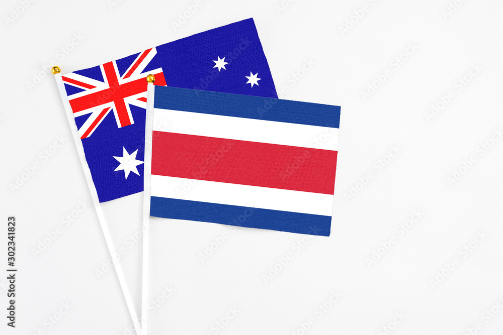 Costa Rica and Australia stick flags on white background. High quality fabric, miniature national flag. Peaceful global concept.White floor for copy space. Costa Rica and Australia stick flags on white background. High quality fabric, miniature national flag. Peaceful global concept.White floor for copy space.