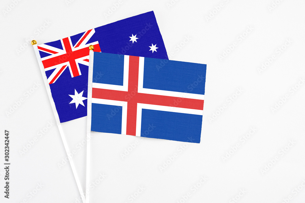 Iceland and Australia stick flags on white background. High quality fabric, miniature national flag. Peaceful global concept.White floor for copy space. Iceland and Australia stick flags on white background. High quality fabric, miniature national flag. Peaceful global concept.White floor for copy space.