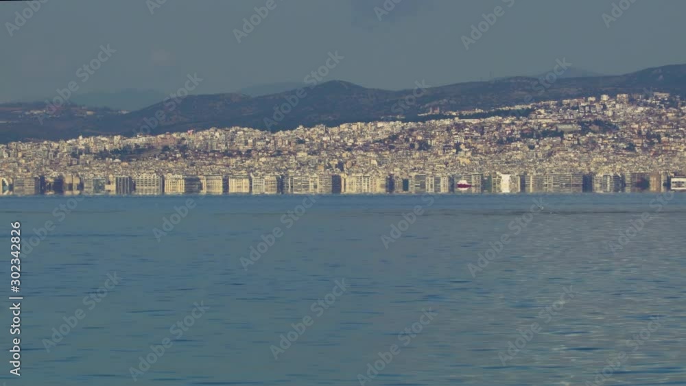 Thessaloniki, Greece landscape coastal view of the city centre. Day view of the capital of the Central Macedonia Greek administrative region with buildings seen on the Thermaic Gulf. Thessaloniki, Greece landscape coastal view of the city centre. Day view of the capital of the Central Macedonia Greek administrative region with buildings seen on the Thermaic Gulf.