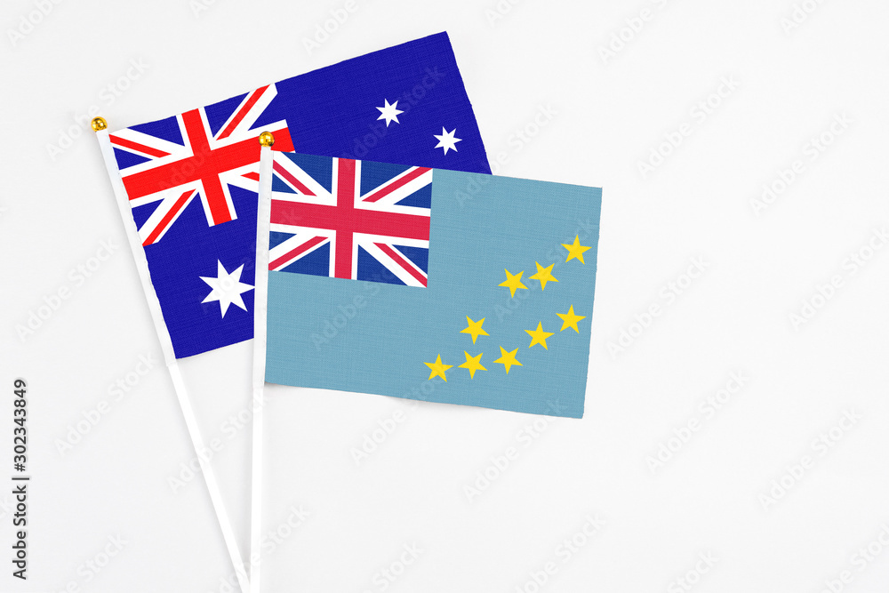 Tuvalu and Australia stick flags on white background. High quality fabric, miniature national flag. Peaceful global concept.White floor for copy space. Tuvalu and Australia stick flags on white background. High quality fabric, miniature national flag. Peaceful global concept.White floor for copy space.