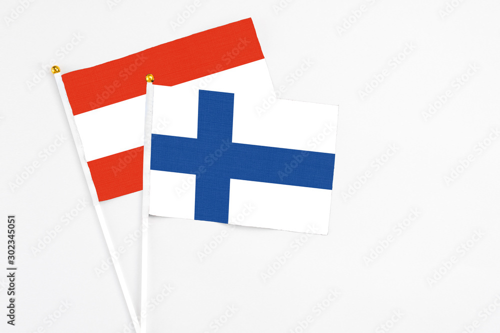 Finland and Austria stick flags on white background. High quality fabric, miniature national flag. Peaceful global concept.White floor for copy space. Finland and Austria stick flags on white background. High quality fabric, miniature national flag. Peaceful global concept.White floor for copy space.