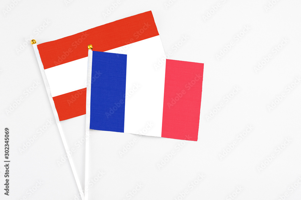 France and Austria stick flags on white background. High quality fabric, miniature national flag. Peaceful global concept.White floor for copy space. France and Austria stick flags on white background. High quality fabric, miniature national flag. Peaceful global concept.White floor for copy space.