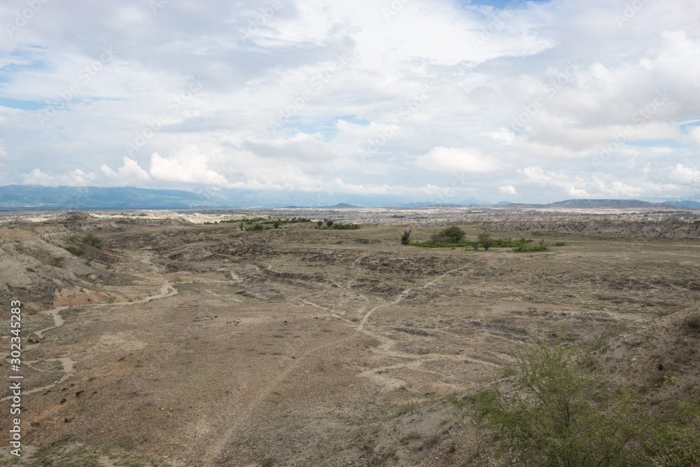 Los Hoyos Landscape with some trekking roads, mountains, and clouds background at Tatacoa Desert, Huila, 