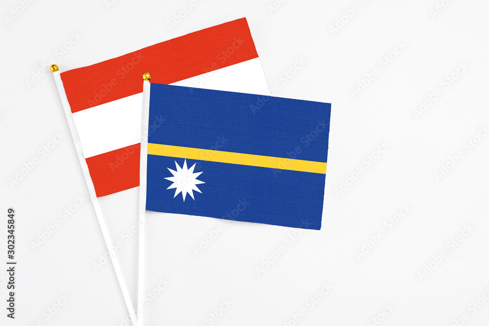 Nauru and Austria stick flags on white background. High quality fabric, miniature national flag. Peaceful global concept.White floor for copy space. Nauru and Austria stick flags on white background. High quality fabric, miniature national flag. Peaceful global concept.White floor for copy space.