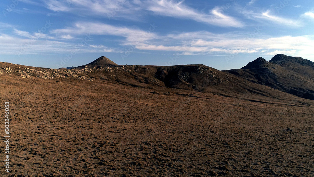 Naklejka premium Arid land on a hill and sky