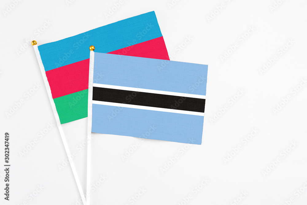 Botswana and Azerbaijan stick flags on white background. High quality fabric, miniature national flag. Peaceful global concept.White floor for copy space. Botswana and Azerbaijan stick flags on white background. High quality fabric, miniature national flag. Peaceful global concept.White floor for copy space.