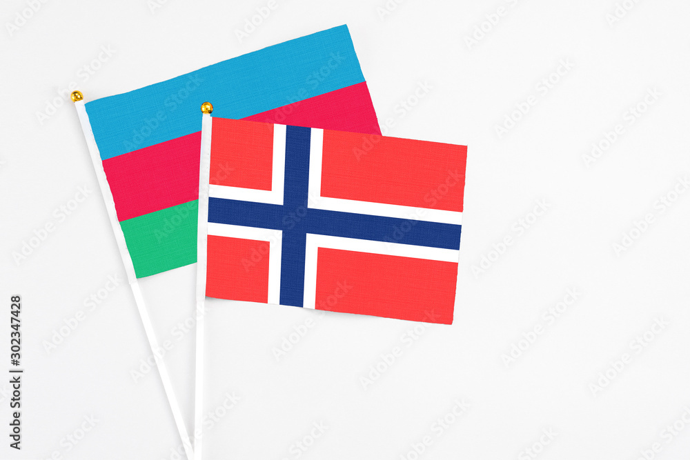 Bouvet Islands and Azerbaijan stick flags on white background. High quality fabric, miniature national flag. Peaceful global concept.White floor for copy space.