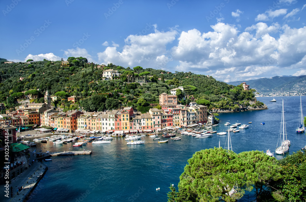 Sea bay with beautiful picturesque village called Portofino. Small marina port at the foot of mountain with a beautiful colourful houses village