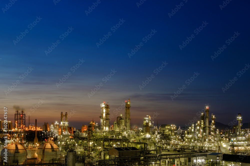 Twilight sky with petrochemical industry estate, glitter lighting of petrochemical industrial on blue sky twilight background