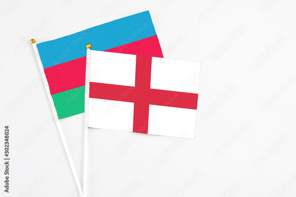 England and Azerbaijan stick flags on white background. High quality fabric, miniature national flag. Peaceful global concept.White floor for copy space.