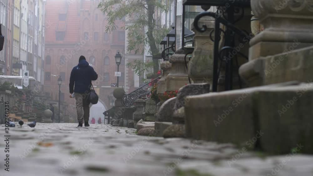Anonymous People Walking Old Town Streets on Foggy Morning, Gdansk Poland Anonymous People Walking Old Town Streets on Foggy Morning, Gdansk Poland