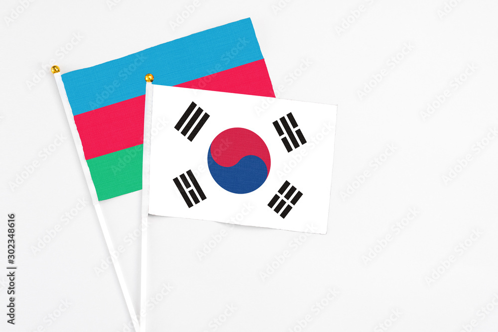 South Korea and Azerbaijan stick flags on white background. High quality fabric, miniature national flag. Peaceful global concept.White floor for copy space.