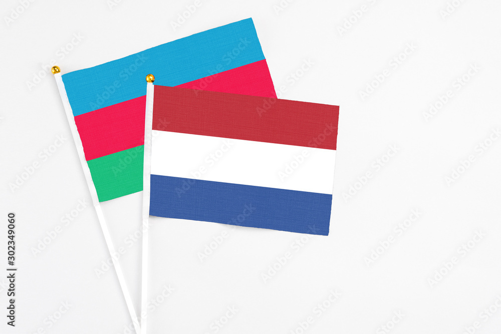 Netherlands and Azerbaijan stick flags on white background. High quality fabric, miniature national flag. Peaceful global concept.White floor for copy space. Netherlands and Azerbaijan stick flags on white background. High quality fabric, miniature national flag. Peaceful global concept.White floor for copy space.