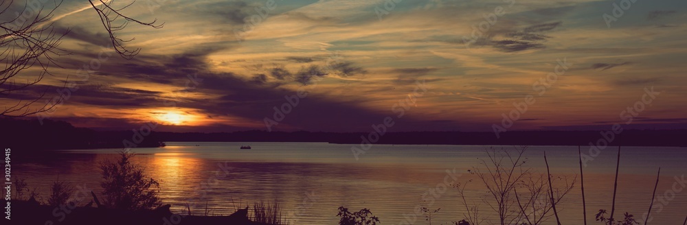 Sunset over Bay of Water with silhouette shoreline Sunset over Bay of Water with silhouette shoreline