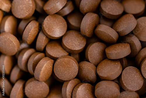 Brown iron supplement pills in the hands