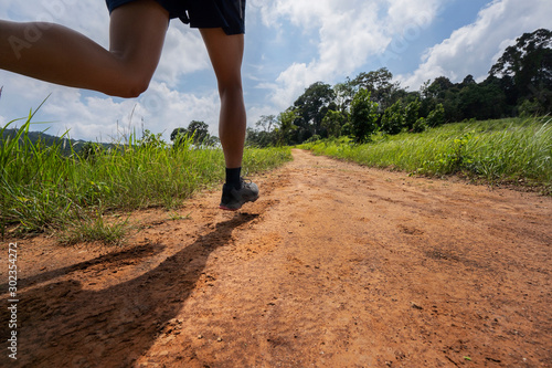 Asian men are running a trail In the natural path