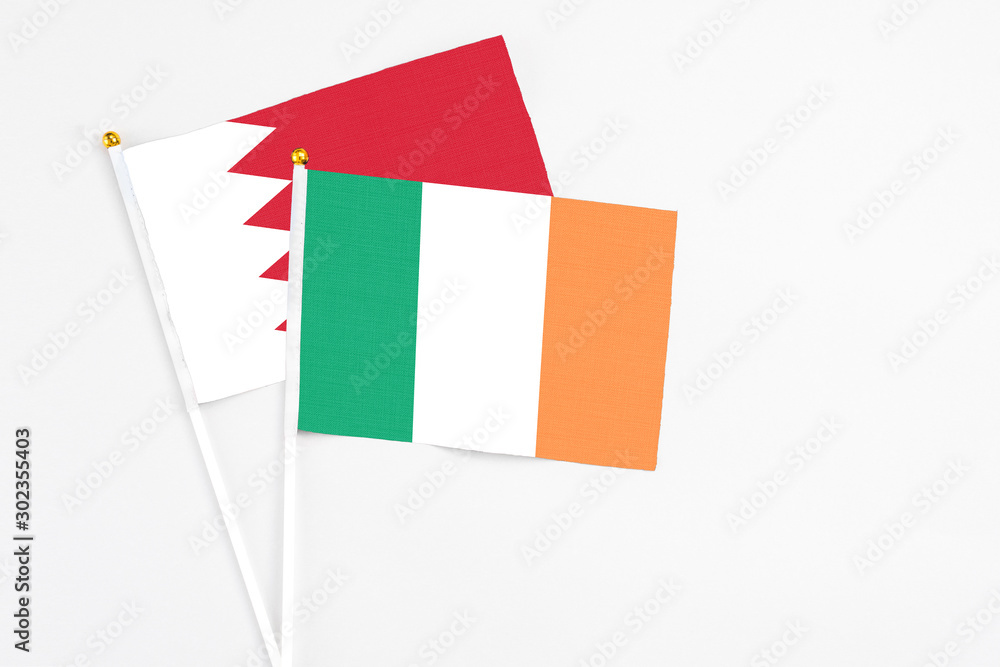 Ireland and Bahrain stick flags on white background. High quality fabric, miniature national flag. Peaceful global concept.White floor for copy space. Ireland and Bahrain stick flags on white background. High quality fabric, miniature national flag. Peaceful global concept.White floor for copy space.
