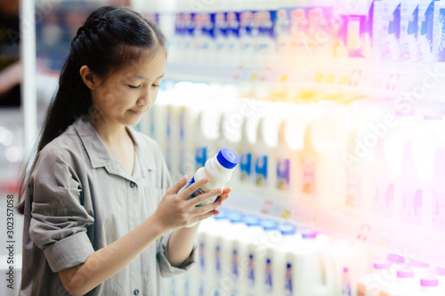 girl shopping milk in market