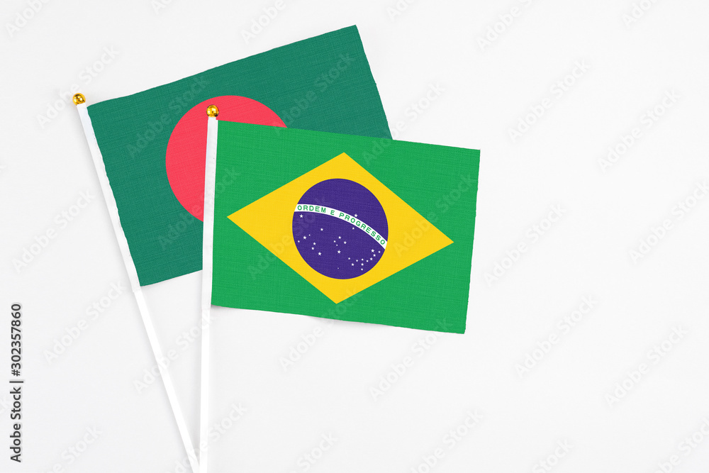 Brazil and Bangladesh stick flags on white background. High quality fabric, miniature national flag. Peaceful global concept.White floor for copy space.
