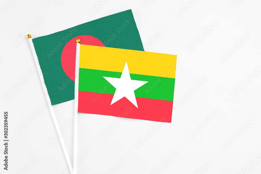Myanmar and Bangladesh stick flags on white background. High quality fabric, miniature national flag. Peaceful global concept.White floor for copy space. Myanmar and Bangladesh stick flags on white background. High quality fabric, miniature national flag. Peaceful global concept.White floor for copy space.