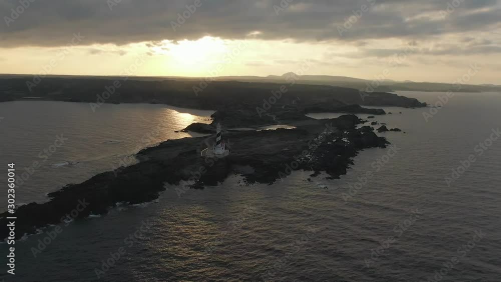 Distance look to the Favaritx Lighthouse under the sunset in Menorca Distance look to the Favaritx Lighthouse under the sunset in Menorca