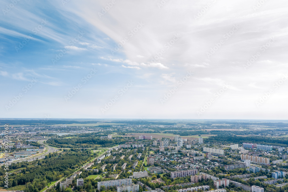 Obraz premium aerial panoramic image of cityscape of Minsk. residential area under blue sky in summer
