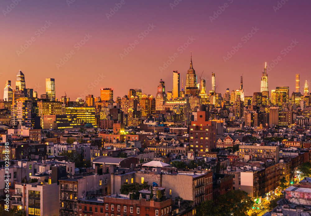 Manhattan tall buildings during orange sunset. New York City panorama. Sky made up with orange tone