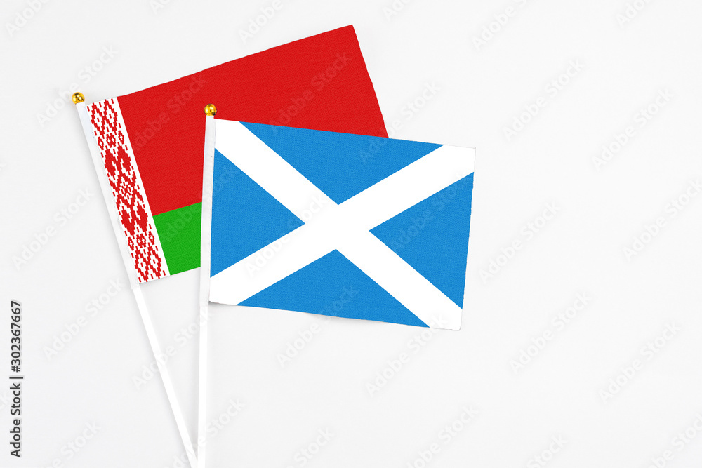 Scotland and Belarus stick flags on white background. High quality fabric, miniature national flag. Peaceful global concept.White floor for copy space. Scotland and Belarus stick flags on white background. High quality fabric, miniature national flag. Peaceful global concept.White floor for copy space.