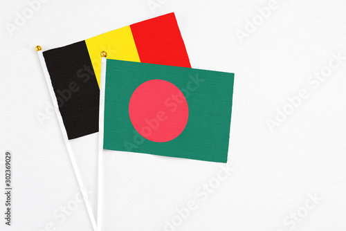 Bangladesh and Belgium stick flags on white background. High quality fabric, miniature national flag. Peaceful global concept.White floor for copy space. Free Download Bangladesh and Belgium stick flags on white background. High quality fabric, miniature national flag. Peaceful global concept.White floor for copy space. - GFXLoad