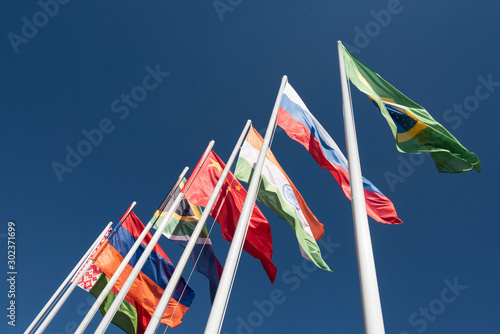 Flags of the BRICS countries in the blue sky