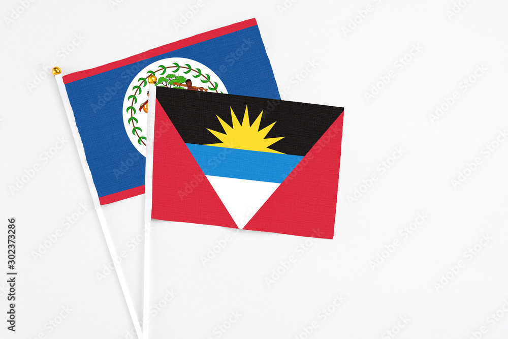 Antigua and Barbuda and Belize stick flags on white background. High quality fabric, miniature national flag. Peaceful global concept.White floor for copy space. Antigua and Barbuda and Belize stick flags on white background. High quality fabric, miniature national flag. Peaceful global concept.White floor for copy space.
