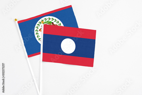 Free Download Laos and Belize stick flags on white background. High quality fabric, miniature national flag. Peaceful global concept.White floor for copy space. - GFXLoad
