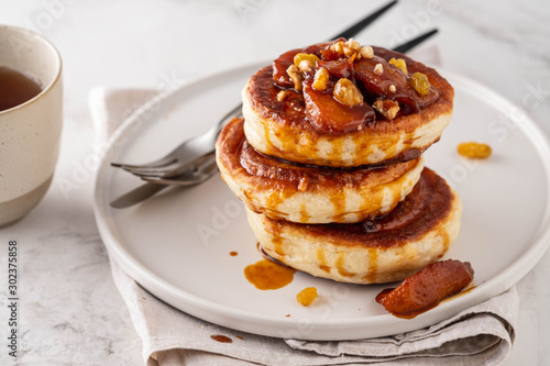 Pancake stacked with maple syrup and apple fruit. Copy space.