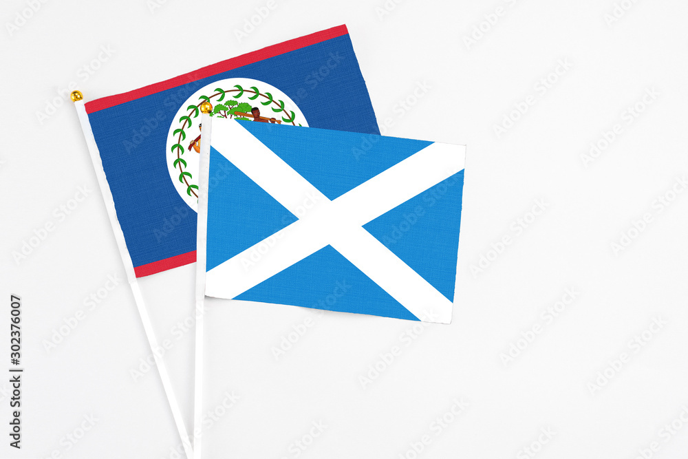 Scotland and Belize stick flags on white background. High quality fabric, miniature national flag. Peaceful global concept.White floor for copy space. Scotland and Belize stick flags on white background. High quality fabric, miniature national flag. Peaceful global concept.White floor for copy space.
