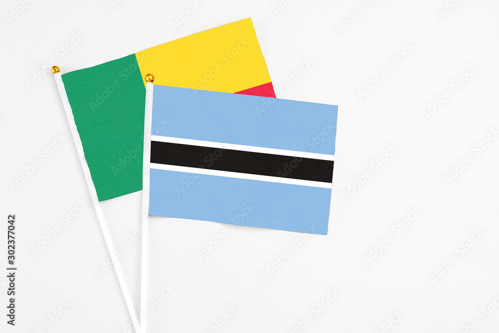 Botswana and Benin stick flags on white background. High quality fabric, miniature national flag. Peaceful global concept.White floor for copy space. Botswana and Benin stick flags on white background. High quality fabric, miniature national flag. Peaceful global concept.White floor for copy space.