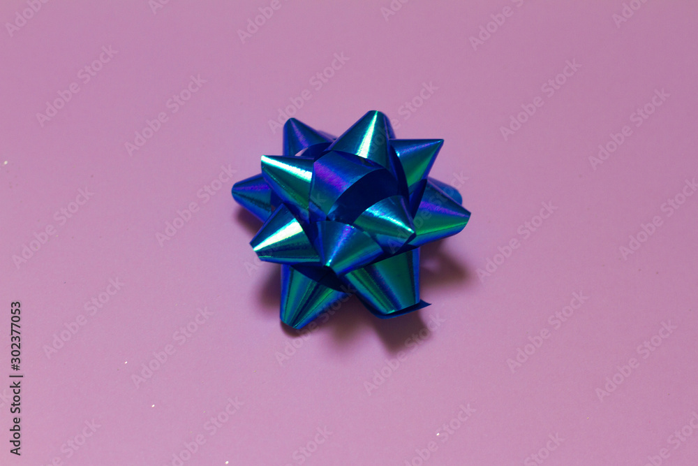blue bow on pink background. for postcards. blue bow. new year and Christmas. space for text. the view from the top. layout on pink background. 2020. blue bow on pink background. for postcards. blue bow. new year and Christmas. space for text. the view from the top. layout on pink background. 2020.