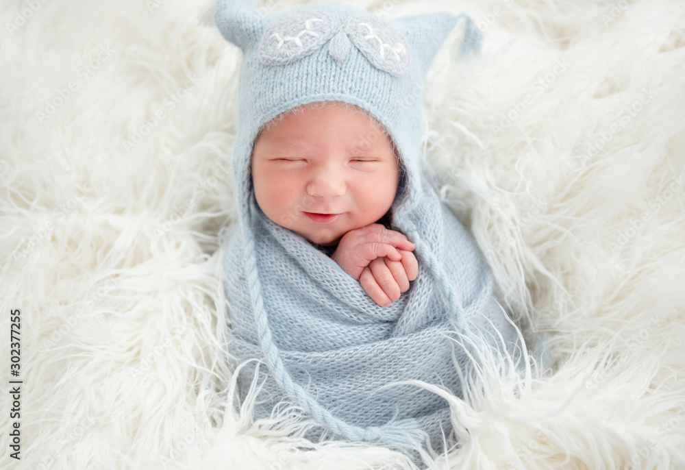 Cute newborn in knitted suit