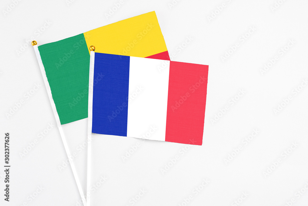 France and Benin stick flags on white background. High quality fabric, miniature national flag. Peaceful global concept.White floor for copy space. France and Benin stick flags on white background. High quality fabric, miniature national flag. Peaceful global concept.White floor for copy space.