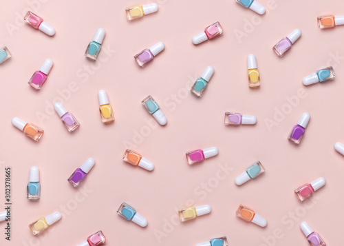 Nail polish pattern. Pastel colors. Pink background. Top view.