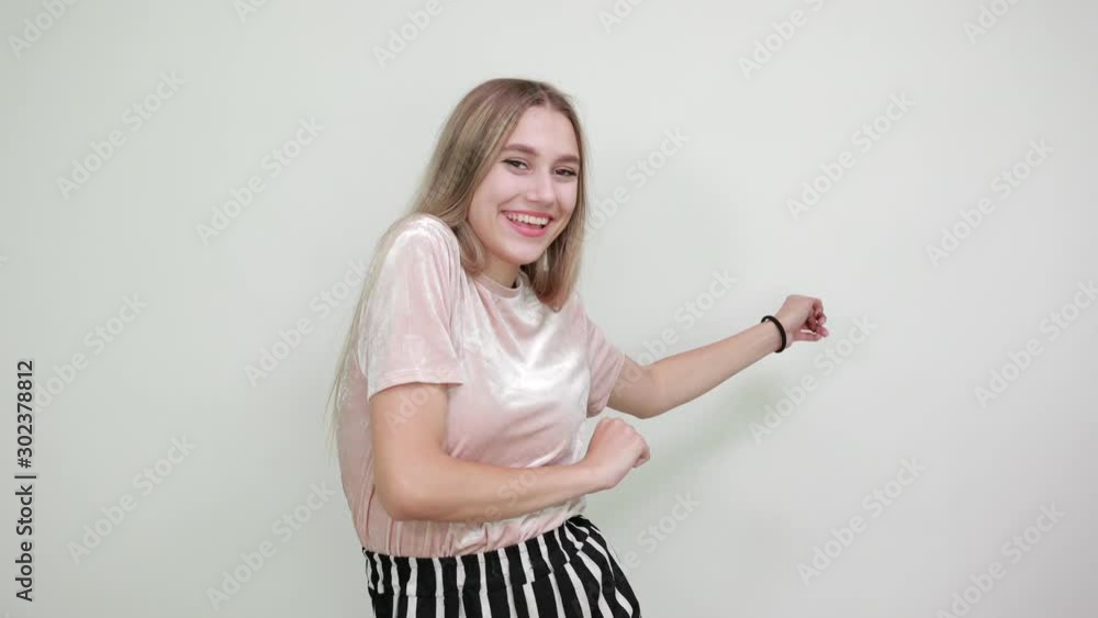 Beautiful blonde caucasian young lady wearing pretty shirt staying over isolation white background pointing away his finger into distance aside Beautiful blonde caucasian young lady wearing pretty shirt staying over isolation white background pointing away his finger into distance aside