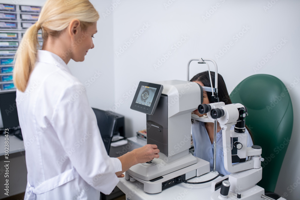 Screen showing eye of patient while eye doctor making examination Screen showing eye of patient while eye doctor making examination