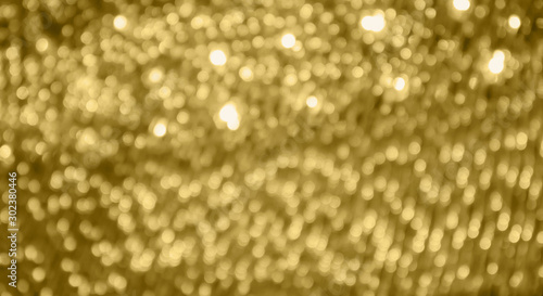 Abstract gold bokeh light festive defocused blur background