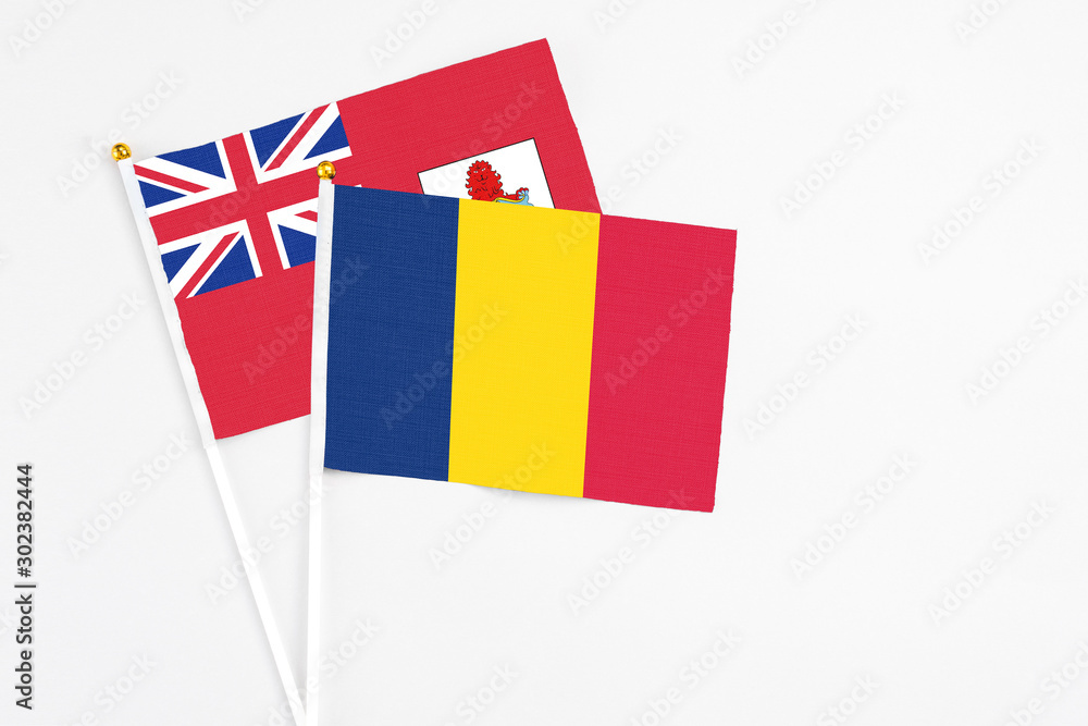 Chad and Bermuda stick flags on white background. High quality fabric, miniature national flag. Peaceful global concept.White floor for copy space. Chad and Bermuda stick flags on white background. High quality fabric, miniature national flag. Peaceful global concept.White floor for copy space.