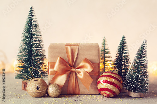 Christmas Composition with present box and christmas tree on neutral background. Holiday greeting card.