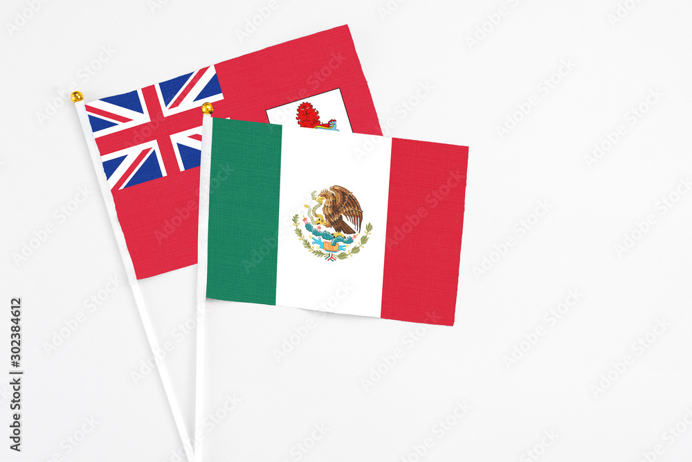 Mexico and Bermuda stick flags on white background. High quality fabric, miniature national flag. Peaceful global concept.White floor for copy space. Mexico and Bermuda stick flags on white background. High quality fabric, miniature national flag. Peaceful global concept.White floor for copy space.