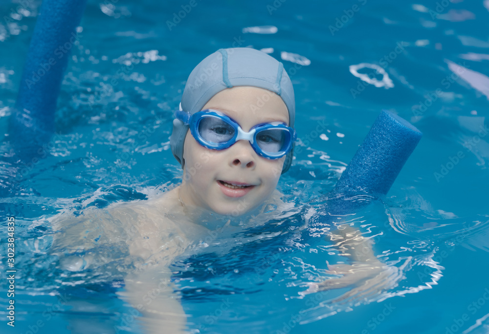 portrait of a boy in swimming goggles in the pool
