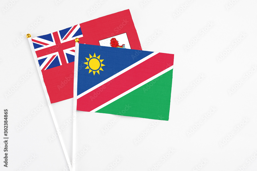 Namibia and Bermuda stick flags on white background. High quality fabric, miniature national flag. Peaceful global concept.White floor for copy space. Namibia and Bermuda stick flags on white background. High quality fabric, miniature national flag. Peaceful global concept.White floor for copy space.