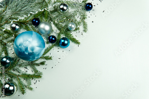 Modern Christmas composition. Christmas balls, blue and silver decorations on white background. Flat lay, top view, copy space. close up photo. can be used us postcard or Christmas banner