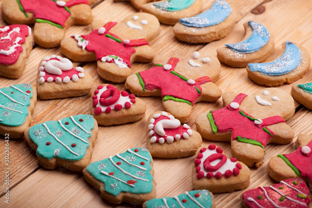 beautiful New Year and Christmas colorful cookies photographed on a wooden background beautiful New Year and Christmas colorful cookies photographed on a wooden background
